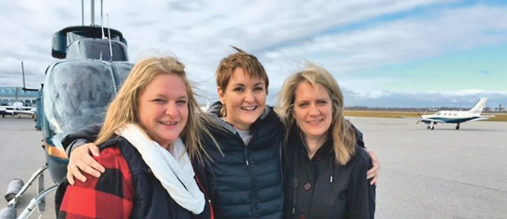 Angie Fox, left, Maggie Van Camp and and Kristy Heimstra pose after a helicopter ride over Niagara Falls that was sold in a charity auction at the OYF event in memory of VanCamp and Fox’s husbands and Heimstra’s son, Jaron.  |  Maggie Van Camp photo
