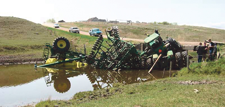 The Saskatchewan air seeder accident image that has made the rounds on the internet and referenced by Brian Olson shows the energy of a loaded seeding unit and how it can overcome a tractor. While brakes might not have prevented this accident, it does show the mass of modern equipment.  |  File photo