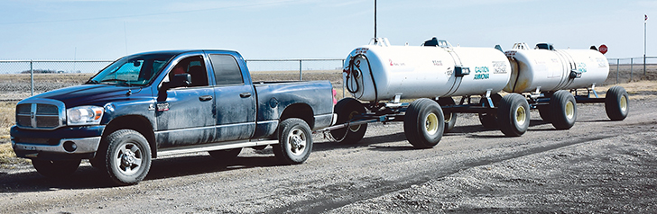 Without trailer brakes and having a wagon-style fifth wheel steering on both wagons, this setup is not allowed in Manitoba, where it was seen. Both brakes and hitching systems are not designed to be used universally behind any machine with a hitch, such as this pickup. |  Glenn Dickson photo