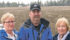 Adele McKechnie, left, John McKechnie and Dale Christian stand at the corner of a field where owners plan to mine gravel. Survey stakes show where a gas line is planned to service the site.
| Brenda Kossowan photo