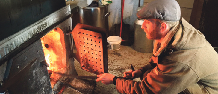 The best syrup is still made in the traditional way with a wood fire to boil down the maple water into syrup. Gabriel Morin tends the fire at Erabliere Maurice Jeannotte near Montreal. It is then filtered, tested for water content and tasted before packaging. | Sarah Galvin photo