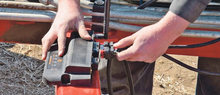 Installing the Legend SA is easy, according to Kris Kennedy.  The sensors are connected in a daisy chain manner, meaning that each sensor simply plugs into the neighbouring sensor, all the way along the entire width of the drill.  Where the the two daisy chains meet in the middle, they plug into the Legend SA module transmitter shown here.  |  Ron Lyseng photo