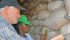 Naomi Manu and Paul Armstrong test moisture stored in bags while gathering data in Ghana on the Post Harvest Loss meter. | ARS-USDA Photo