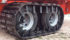 The steel slats hanging down over the tire sidewalls are known as saddles, and they keep the track centred on the tires. On duals, the saddles also have a raised rib down the centre that runs between the two tires. | Right Track photo