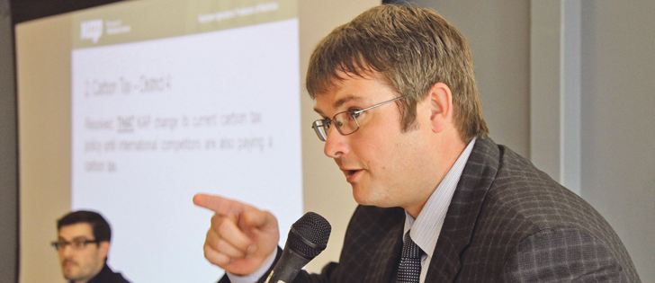 Justin Jenner, Keystone Agricultural Producers vice-president, moderates a 75 minute debate on carbon tax at an April meeting of KAP in Portage la Prairie, Man. The Manitoba government is expected to unveil its plan to reduce greenhouse gas emissions this year and KAP says farmers should be exempt from a carbon tax. | Robert Arnason photo