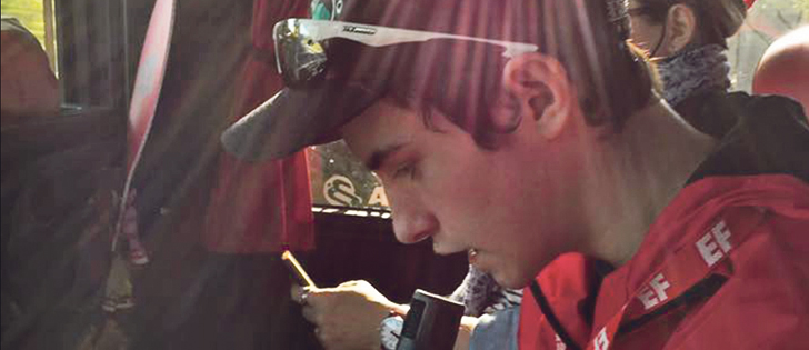 Grade 9 student Curtis Doud reads the profile of his Vimy Ridge soldier while on the bus to the 100th anniversary ceremony in Belgium.  |  Brenda Doud photo