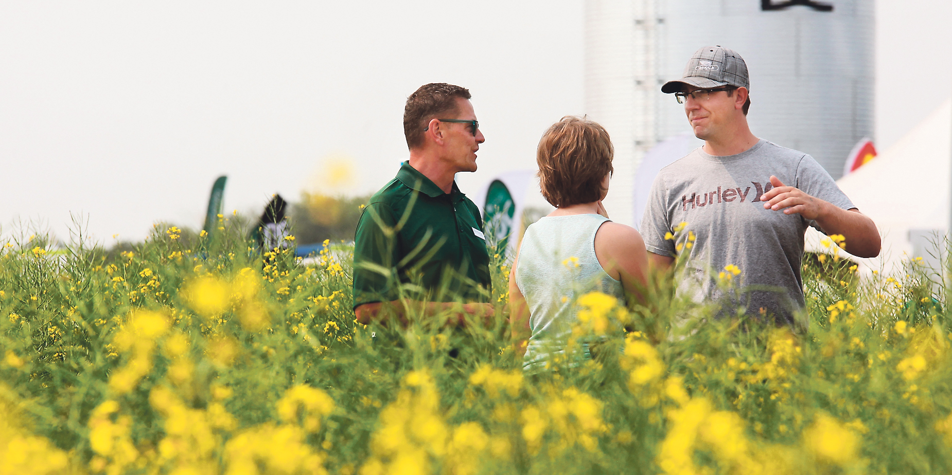 Al VanCaeseele, left, of Brett Young discusses crop genetics with farmers in that company’s Ag In Motion farm show plots. More than 100 acres of the event’s 320 acres of show site are covered with crop plots. |  Michael Raine photo