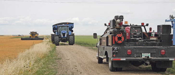 A semi, combine, cart and service truck are coming and going on the Bruce and Eleanor Durie farm between Moose Jaw and Belle Plaine, Sask. Lentil harvest began Aug. 1. |  Karen Briere photo