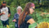 Ben Martens Bartel, left, his mother, Denise Bartel, and his wife, Lisa Martens Bartel, pick peas. | Sean Pratt photo