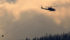 A helicopter flies over a wildfire southwest of Cache Creek, B.C., earlier this summer. Cattle producers continue to struggle with a long, hot fire season.  |  REUTERS/Ben Nelms photo