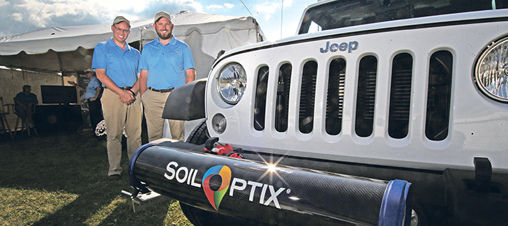 The tube holding the Soiloptix sensor is mounted to the front of the truck and passes over the field, gathering information about what lies below. Paul Raymer, left, and Zack Harmer say their system for collecting soil data can provide producers with a continuous picture of their soils, rather than a series of snapshots.  |  Michael Raine photo