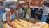 A labourer marks sacks filled with pulses before loading them into a truck as others wait in a queue to load at a wholesale market in Kolkata, India, May 16, 2016. | REUTERS/Rupak De Chowdhuri photo