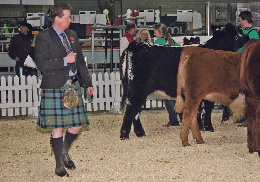 William McLaren of Perth, Scotland, judges the senior showmanship classes at the Farmfair futurity show. He raises about 300 Red and Black Angus and has imported embryos and live cattle from Canada since the 1980s.  |  Barbara Duckworth photo