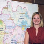 Shannon Frank, executive director of the Oldman Watershed Council, stands in front of a map of the watershed. | File photo