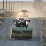 His tractor loaded with two bales for his cattle in another field, Bob Fraser leaves his hay stacks and travels along a back road south of High River, Alta., Dec. 5 | Mike Sturk photo