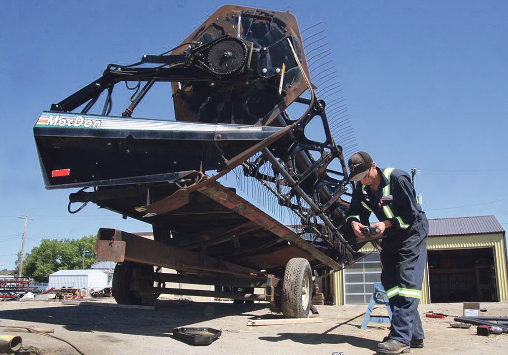 MacDon’s history of providing rugged and unique harvest tools for small grains and oilseeds producers stretches back through modern agriculture’s history. Products like this 972 draper header being updated at Rocky Mountain Equipment in Oyen, Alta., are good examples of long-term reliability of brand.  |  File photo