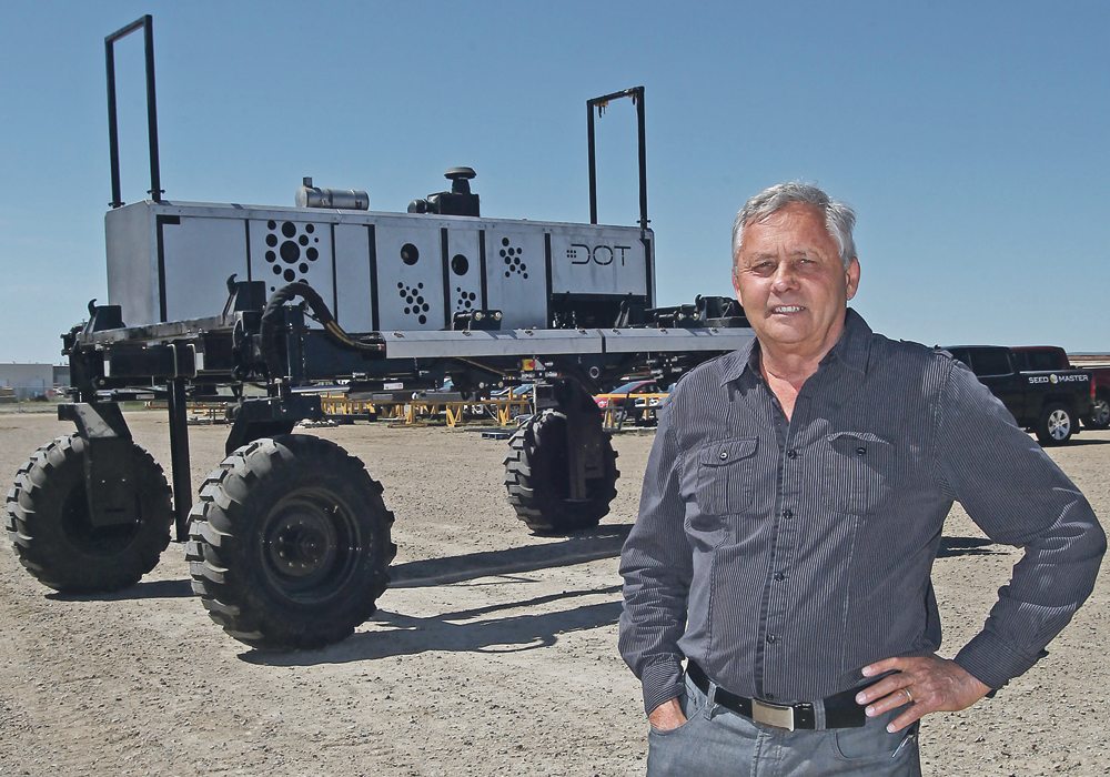 Norbert Beaujot stands with the first DOT powered platform ahead of release last summer. The prototype has a 165 h.p. Tier 4 Cummins engine, which will be swapped for a 200 h.p. Tier 5 in production for 2019. Independent, hydraulic wheel motors guide the machine with sub-inch control. | Michael Raine photo