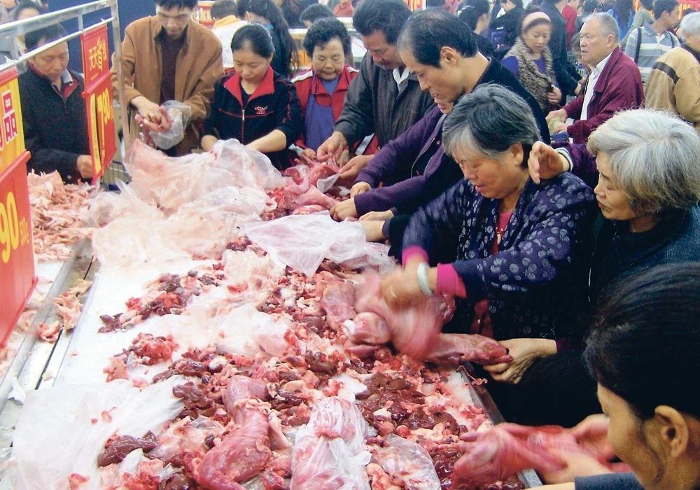 Analysts worry that China’s demand for food will decrease if population estimates for the country prove correct. Here, shoppers check out the rabbit meat counter at a Walmart in Chongqing in central China in this file photo from 2011.  | REUTERS/Terril Yue Jones photo