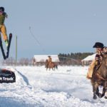 Rylie Harvie pulls Jean Loius Frank over the skijor long jump. | Mike Sturk photo
