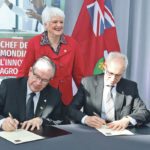 University of Guelph President Dr. Franco Vaccarino, right, and Ontario Agriculture Minister Jeff Leal sign the new research partnership agreement while MPP Liz Sandals watches. | John Greig photo