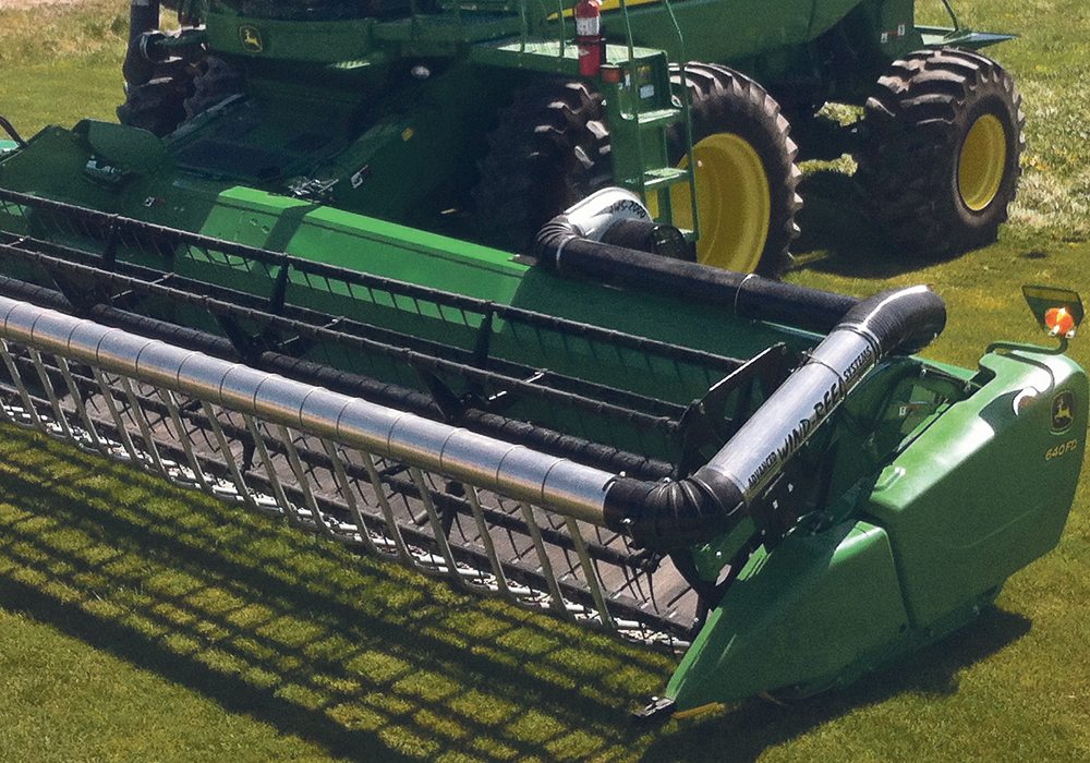 The Airbar system allows faster ground speeds by improving feeding into the header.  The airflow also reduces shatter losses.  |  Carmen Drost photo