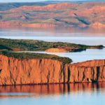 The setting sun illuminates the cliffs of Lake Diefenbaker. | Arlene & Robin Karpan photo