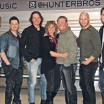 Luke, left, Dusty, JJ, Norma, Lorne, Brock and Ty are always ready to hit the road on their tour bus, but not until the farm work is wrapped up.