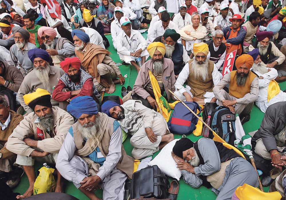 Farmers in New Delhi, India listen to speakers during a rally demanding a complete debt waiver and improved prices for their crops. The politics of grain prices and production are complex in the country.  |  REUTERS/Adnan Abidi