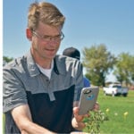 Nolan Kowalchuk tests a smartphone application called Xarvio Weed Scout at a field day June 20. | Barb Glen photo