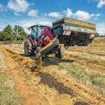MegaMix can be used for a variety of farm applications, including creating these plantation rows with compost and sand. The eight-inch diameter auger not only moves the product in the bucket, but is also capable of mixing heavy materials like concrete. | Danuser photo