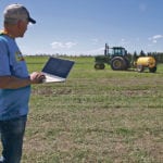 Brian Tischler demonstrates how he’s able to drive his tractor autonomously using software on a laptop. | Jeremy Simes photo