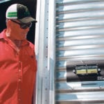 Nearly everyone at Ag In Motion had to test out the inside mechanical sensor on the Grain Gauge. The green indicator tells you the grain level inside is at the level of the non-electronic monitor. For nightime work, the green gauge glows in the dark. | Ron Lyseng photo