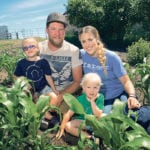 Liam Gauthier and Megz Reynolds hang out in the family’s vegetable garden with their children, Thea, 4, and Rynn, 2. | William DeKay photo