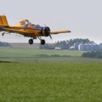 A Westlock, Alta., aerial-spraying company faces four charges for alleged failure to comply with regulations. This photo of a spray plane at work was taken in 2007. | File photo