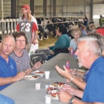 People had breakfast alongside the dairy cows during a Breakfast on the Dairy Farm event held at Airport Dairy near Fort Macleod, Alta., Aug. 11. The dairy, operated by Harvey and Bernita Van Hierden, opened its doors to the public for the event, which was organized by Alberta Milk. | Barb Glen photo
