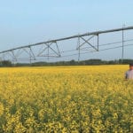Peter Fehr stands with his new irrigation system on his farm near La Crete, Alta. | Photo supplied by Peter Fehr