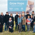 A group of Grow Hope Saskatchewan supporters pose with Olympic gold medalist Cindy Klassen, fifth from left, at the Grow Hope Saskatchewan field just outside of Rosthern, Sask. | Jana Al-Sagheer photo