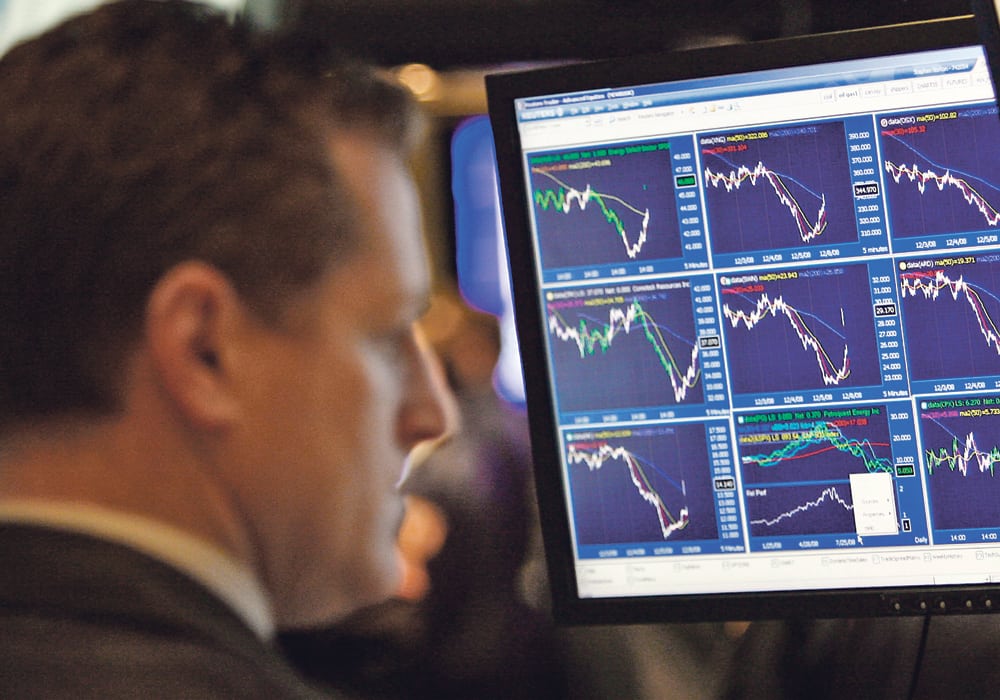 Looking back at trying times. A trader works near a monitor displaying stock prices on the main trading floor of the New York Stock Exchange early in a trading session, Dec. 8, 2008, that was hoped to prevent a major recession.  |  REUTERS/Mike Segar photo
