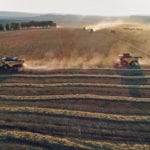 Combines harvest spring wheat on the Solgonskoye farm near the Siberian village of Talniki in the Krasnoyarsk region of Russia in early September. The crop has been better than expected, but will be largely consumed inside Russia for flour milling. | REUTERS/Ilya Naymushin photo