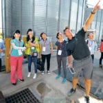 Soybean and corn farmer Marc Kaiser points out features of one of his grain bins to a Chinese trade delegation near Norborne, Missouri, U.S., Aug. 28. Despite his efforts to make his products attractive to Chinese buyers, Kaiser’s soybeans are worth US$2.50 less per bushel than those of other countries in the Chinese market right now. | REUTERS/Dave Kaup photo