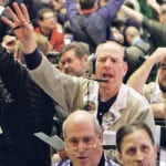 Traders in the corn options pit at the CME Group signal orders shortly before the closing bell in Chicago, Feb. 11, 2011. Large speculators trimmed their net-long stakes in Chicago Board of Trade corn futures and options by adding shorts to their position as prices approached 2-1/2-year highs. | REUTERS/Frank Polich photo