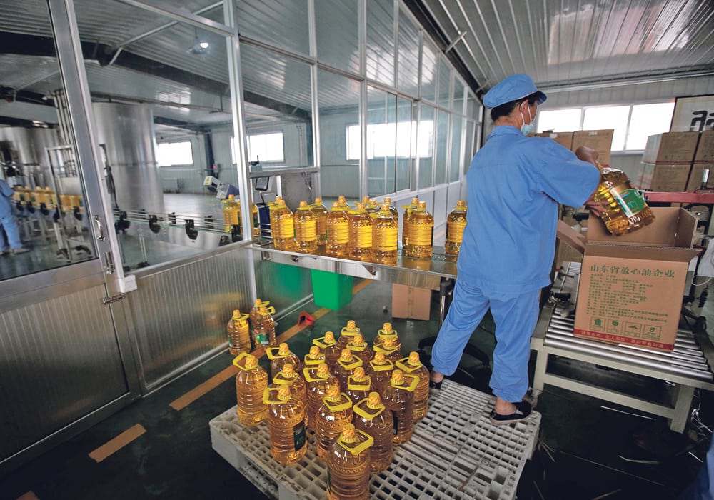 A worker packs bottles of vegetable oil made from U.S. grown soybeans at the Liangyou Industry and Trade Co., plant in Qufu, Shandong province, China. That was July 4. Currently, supplies of beans to crush are reportedly coming from Brazil.  |  REUTERS / Jason Lee photo