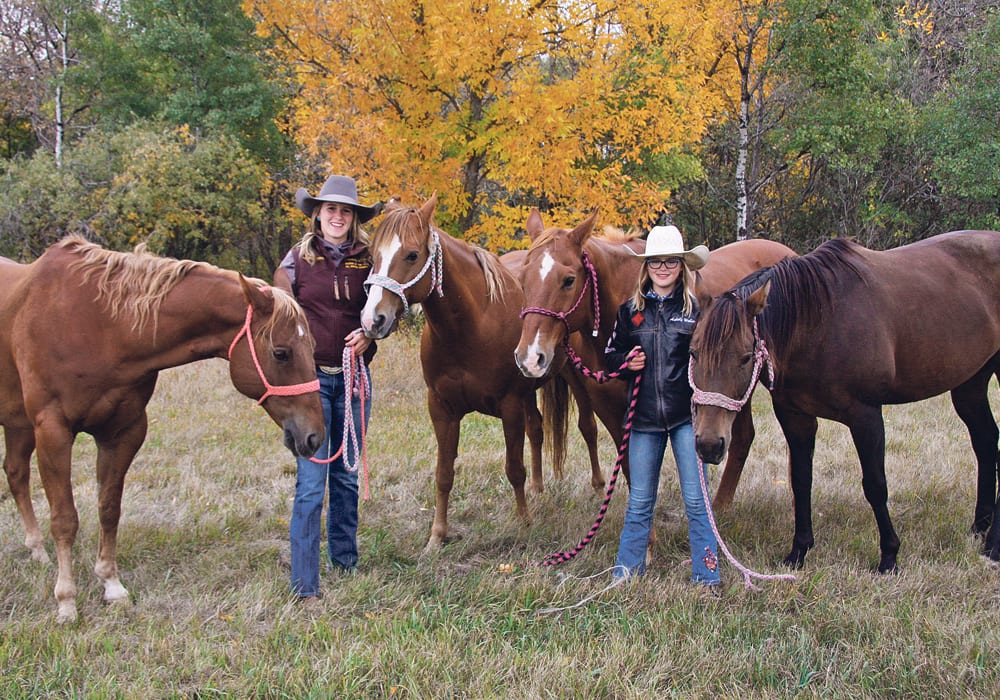 Cassidy, left, and Ashley Weber, spend time with their rodeo horses on the family farm near Carlyle, Sask.  | Karen Briere photo