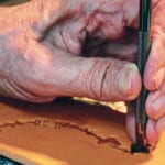 Brian Ironmonger stamps all of his saddle decorations by hand, one stamp at a time. Christalee Froese photo