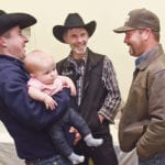 Garret Poletz holds six-month-old daughter Houstyn while talking with Ike Wipf and Joel Kampen during the Saskatchewan Cattlemen’s Association district 7 meeting in Kindersley Oct. 22. | William DeKay photo