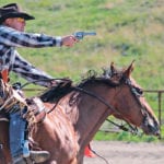 Niels Lausten competes at a 2014 shoot in Aylesbury, Sask., on his gelding, Ranger. Mounted shooters use .45 calibre single action revolvers. The gun must be cocked each time before firing by drawing the hammer back. Other firearms in the sport include rifles and double barrel shotguns. All use blank ammunition. | Cheryl La Rue photo