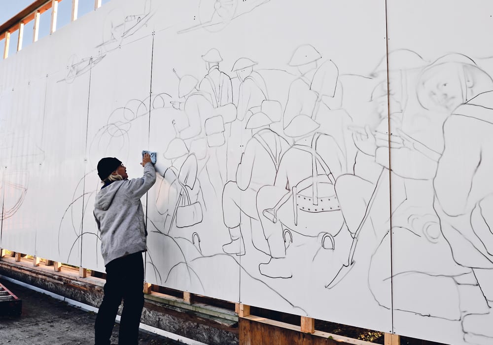  John Ellenberger wipes the morning condensation from a mural he’s working on in the open air at his acreage home. He’s redoing a memorial mural honouring soldiers who fought during the First World War and Second World War that he painted in the early 1990s. The mural will be installed at the Royal Canadian Legion in Iriquois, Ont.  |  Maria Johnson photo