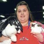 Sharin Engler holds a French lop rabbit, which weighs about 14 pounds, and a Little Polish rabbit, which weighs about 2.5 lb. Rabbits came back to Farmfair International after a long absence. | Barbara Duckworth photo