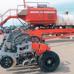 The machines are custom built, but this one is set up as a 60-foot-wide single tool bar that sits on tracks and has been fitted with a commodity and liquid tank on the planter’s main frame. The tank holds about 100 bushels of on-frame storage of seed, which is usually enough for corn or canola.“You can get 200 acres of corn in, no problem, and canola you can go for days. But when it comes to soybeans that works out to be about an 80-acre fill. But in Western Canada, a lot of our fields are much, much bigger than that,” Frank Prince said. | Robin Booker photo