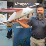 Andrew Carson of Draganfly Innovations shows the company’s Tango fixed-wing drone. | Michael Robin photo
